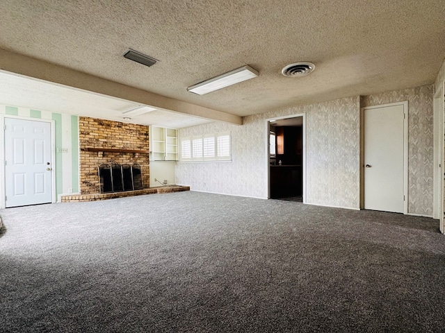 unfurnished living room with a brick fireplace, a textured ceiling, and carpet floors