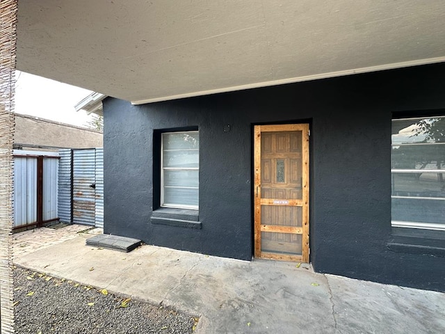 property entrance with stucco siding