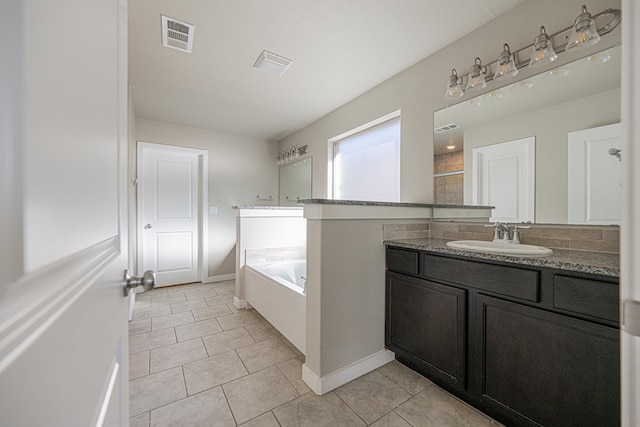 bathroom featuring tile patterned flooring, shower with separate bathtub, and vanity