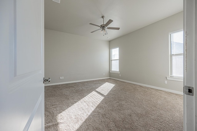 unfurnished room featuring carpet, ceiling fan, and plenty of natural light