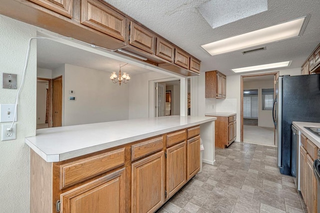 kitchen with kitchen peninsula, pendant lighting, a textured ceiling, and an inviting chandelier