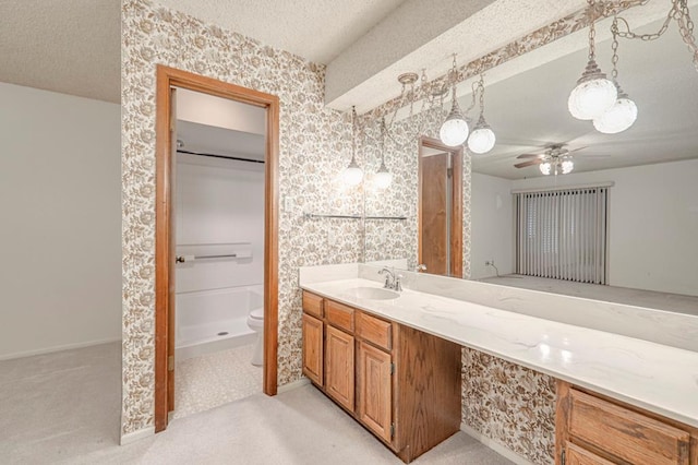 bathroom featuring walk in shower, a textured ceiling, vanity, ceiling fan, and toilet