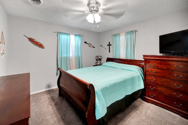 bedroom featuring ceiling fan, carpet floors, and a textured ceiling