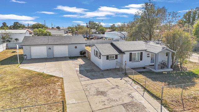 view of front of property featuring an outbuilding, a garage, and a front lawn