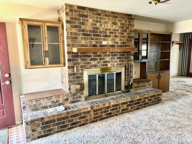 living room with a fireplace and carpet flooring