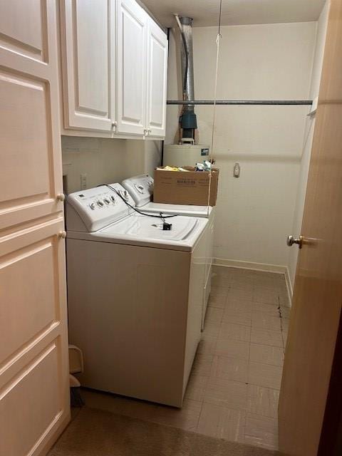 clothes washing area with cabinets and independent washer and dryer