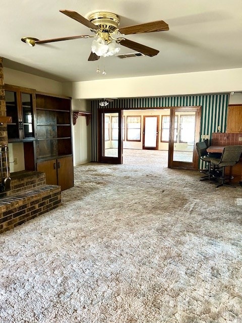 living room featuring carpet, french doors, and ceiling fan