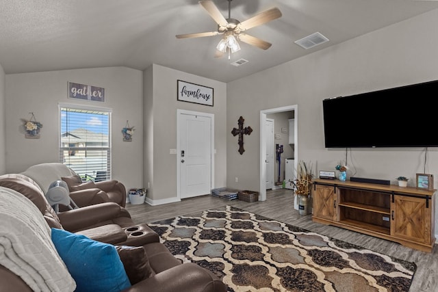 living room with vaulted ceiling, ceiling fan, and light hardwood / wood-style floors