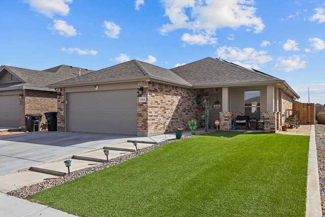 view of front of home featuring a garage, a front yard, and covered porch