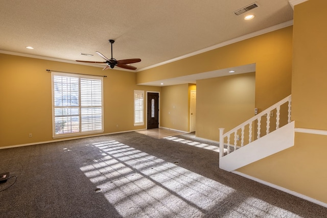 unfurnished living room featuring ornamental molding, carpet, visible vents, and baseboards