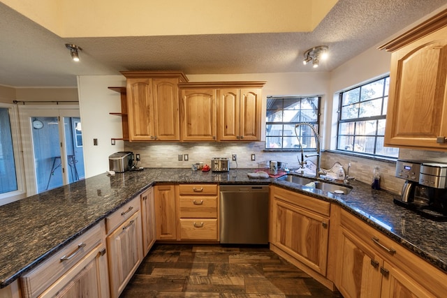 kitchen with open shelves, tasteful backsplash, stainless steel dishwasher, a sink, and dark stone countertops