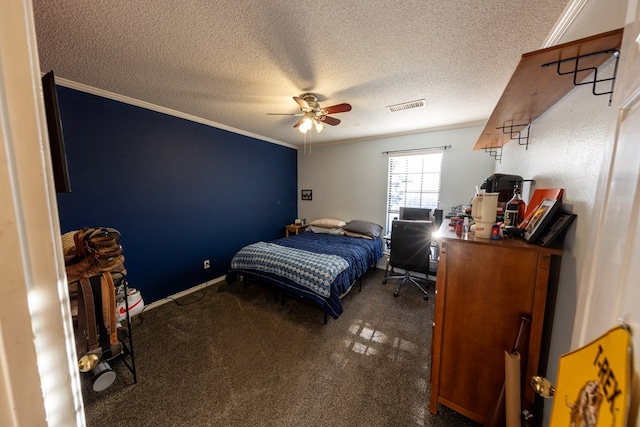 bedroom with visible vents, a ceiling fan, ornamental molding, a textured ceiling, and carpet floors