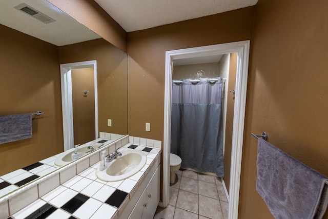 bathroom featuring a shower with curtain, visible vents, toilet, vanity, and tile patterned flooring