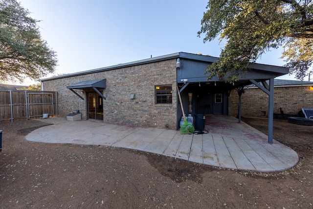 back of property with a patio area and fence