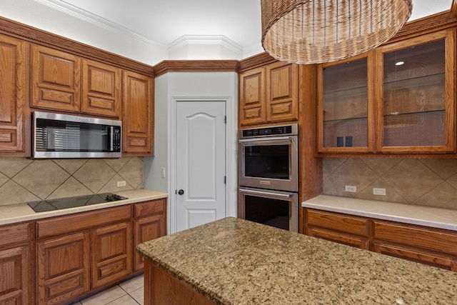 kitchen featuring backsplash, appliances with stainless steel finishes, light tile patterned flooring, and ornamental molding