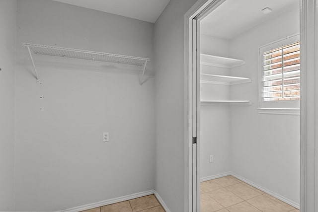 spacious closet featuring light tile patterned floors