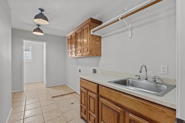 clothes washing area featuring light tile patterned floors, hookup for an electric dryer, washer hookup, cabinets, and sink