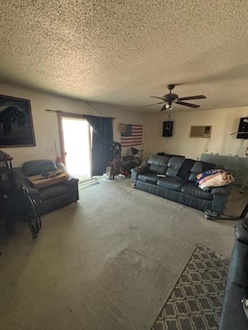 clothes washing area with washing machine and dryer and a textured ceiling