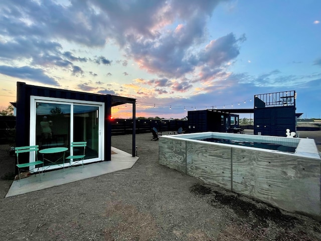 view of patio terrace at dusk