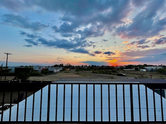 pool at dusk featuring a water view