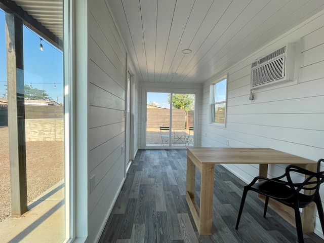 sunroom / solarium with a wall mounted air conditioner and wood ceiling