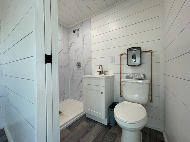 bathroom with hardwood / wood-style floors, vanity, toilet, and walk in shower