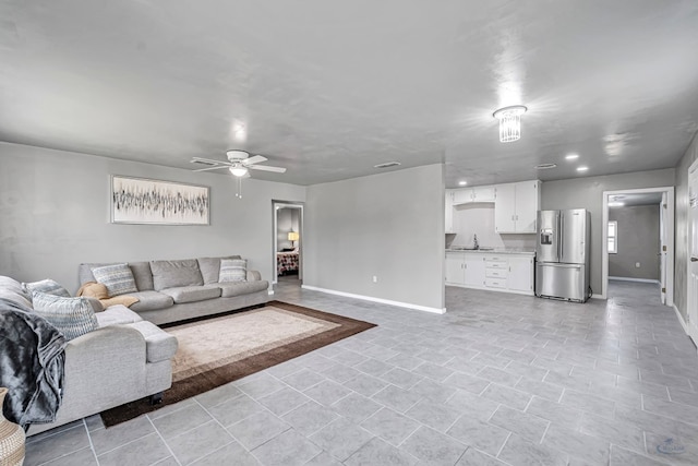 living room with ceiling fan and sink