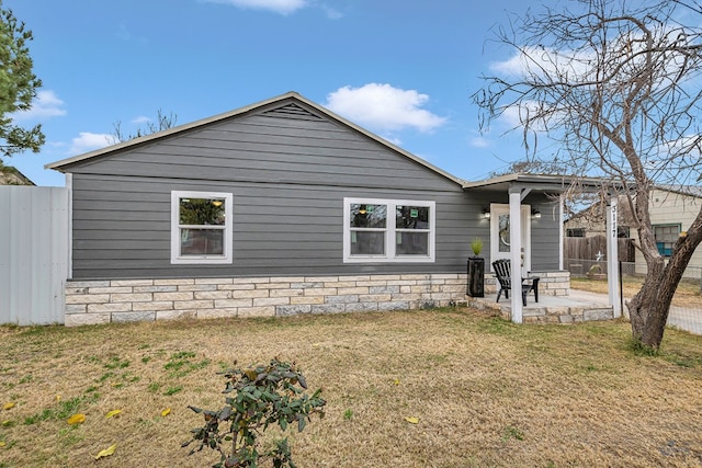 view of side of home with a yard