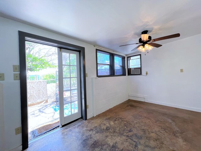 doorway with concrete flooring, a wealth of natural light, cooling unit, and ceiling fan