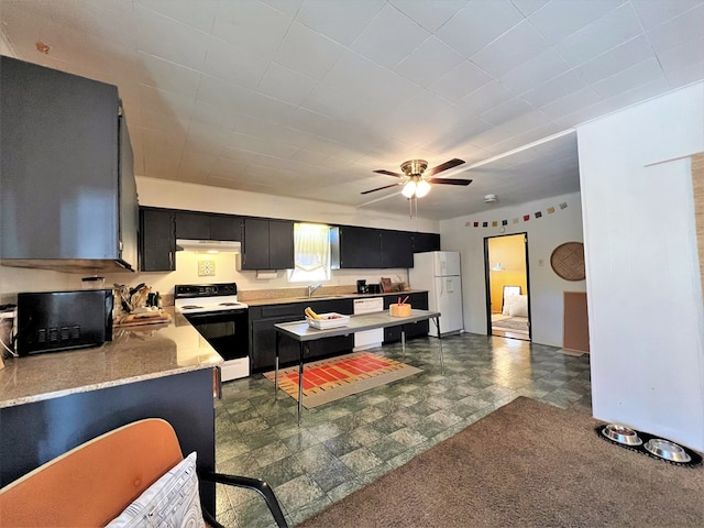 kitchen featuring white appliances and ceiling fan