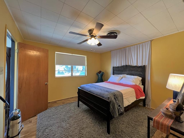 bedroom with hardwood / wood-style flooring and ceiling fan