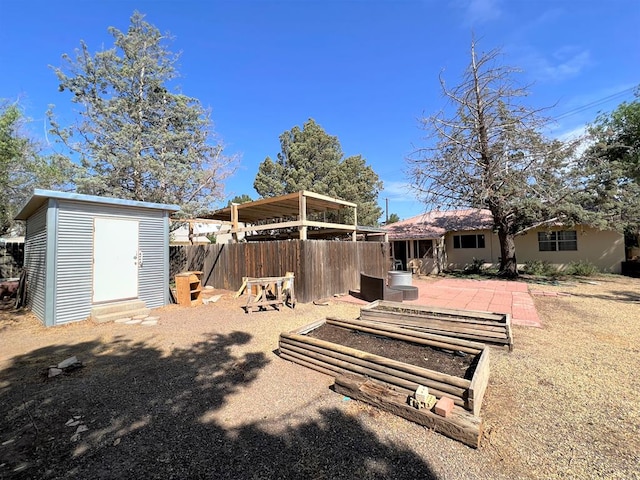 back of house with a patio area and a storage shed