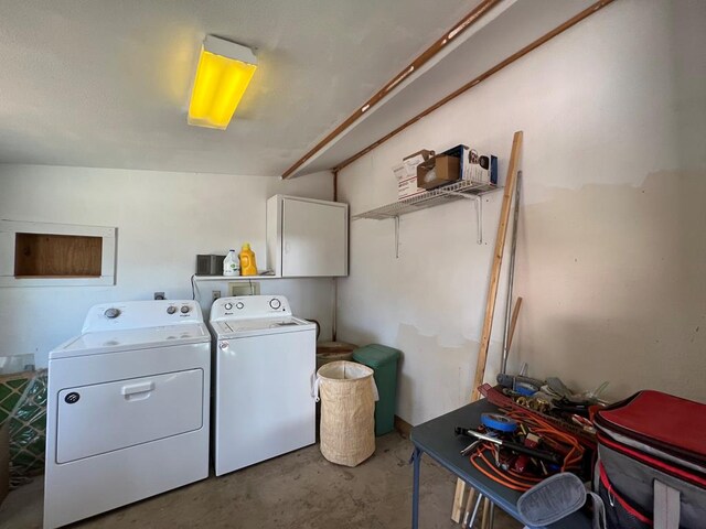 laundry area featuring cabinets and washing machine and clothes dryer