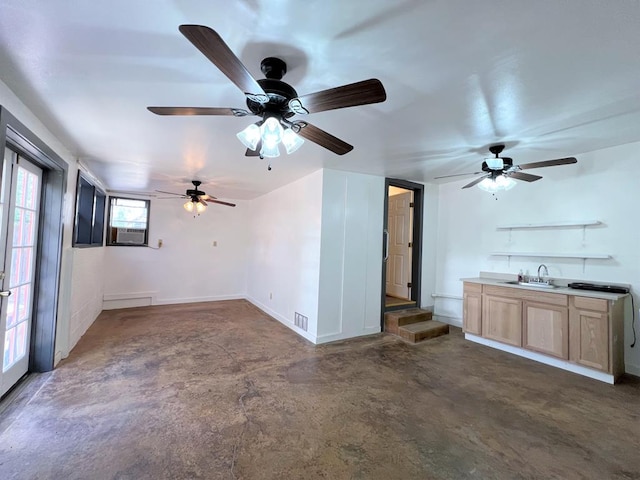 unfurnished living room featuring cooling unit and sink