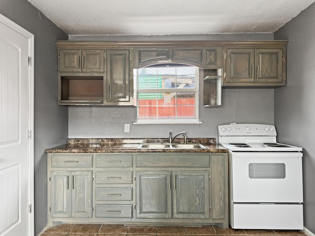 kitchen with a textured ceiling, white range with electric cooktop, and sink