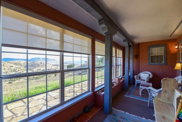 sunroom featuring a mountain view