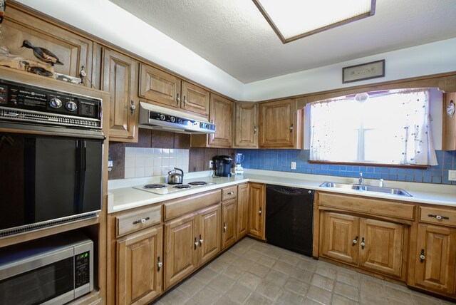 kitchen with dishwasher, decorative backsplash, white cooktop, and sink