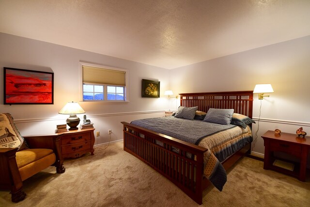 carpeted bedroom featuring a textured ceiling