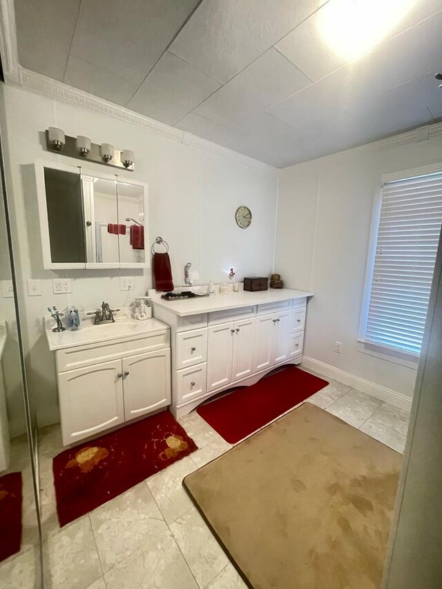 bathroom with vanity and ornamental molding