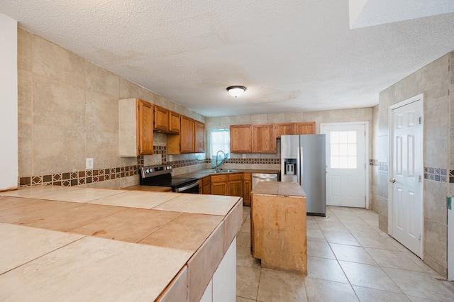 kitchen with sink, a center island, plenty of natural light, and appliances with stainless steel finishes