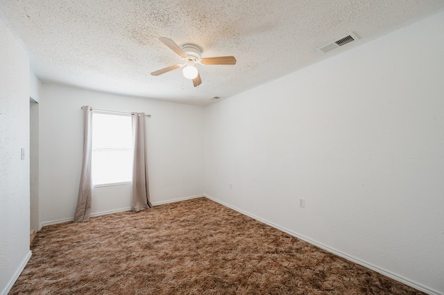 spare room featuring carpet flooring, ceiling fan, and a textured ceiling