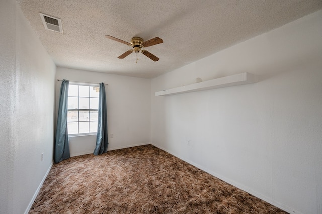 carpeted spare room with ceiling fan and a textured ceiling