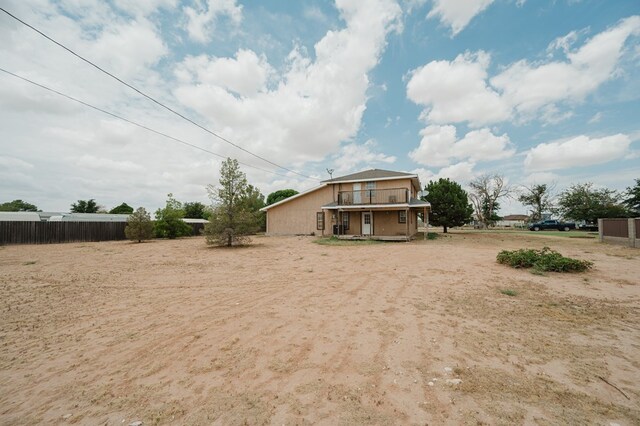 rear view of property featuring a balcony