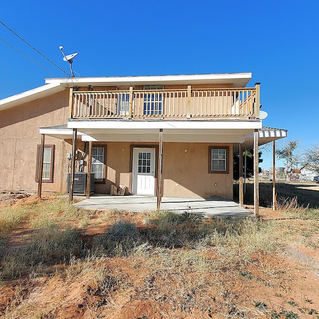 back of house with a patio