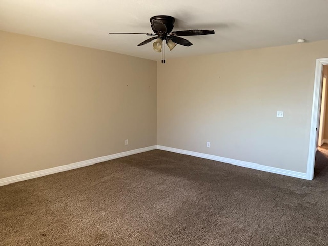 empty room featuring ceiling fan and dark colored carpet