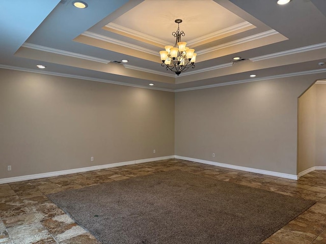 carpeted empty room featuring a chandelier, a raised ceiling, and crown molding