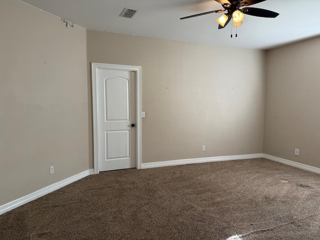 carpeted spare room featuring ceiling fan