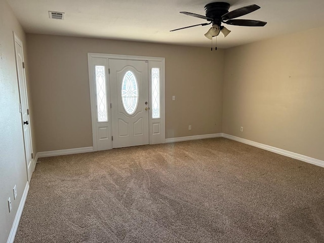 carpeted entryway featuring ceiling fan