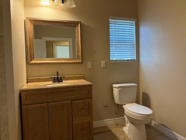 bathroom with tile patterned flooring, vanity, and toilet