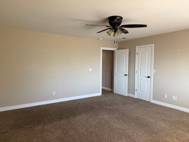 unfurnished room featuring ceiling fan and carpet